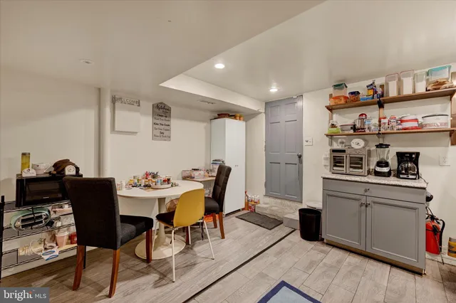 a view of a dining room with furniture and a kitchen
