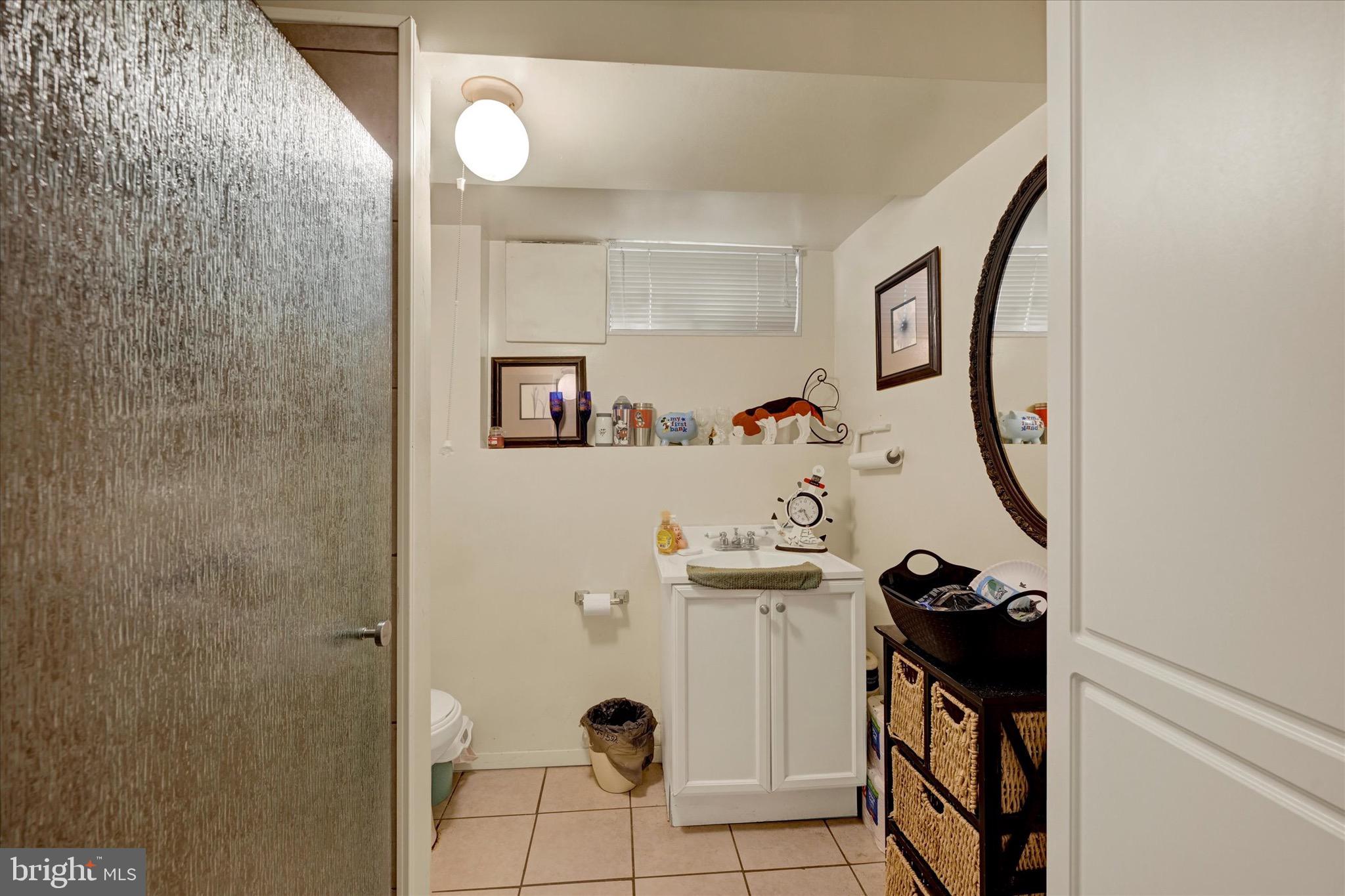 3922 Mortimer Avenue Baltimore, MD 21215 - Photo 23 of 27 a bathroom with a sink and mirror