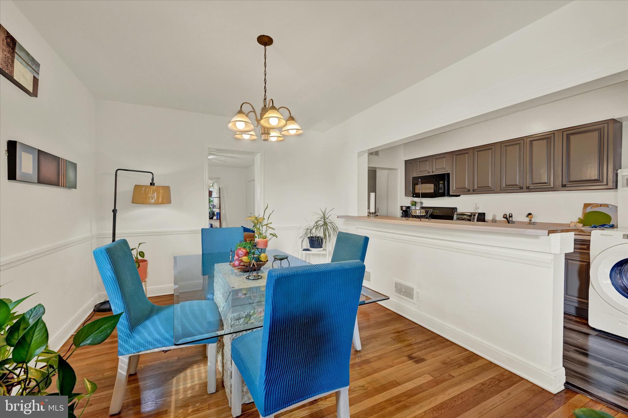 3922 Mortimer Avenue Baltimore, MD 21215 - Photo 7 of 27 a dining room with furniture a chandelier and wooden floor