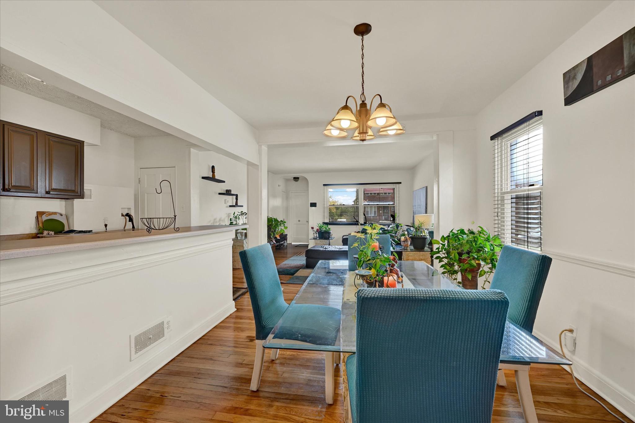 3922 Mortimer Avenue Baltimore, MD 21215 - Photo 9 of 27 a view of a dining room and a kitchen with a table chairs