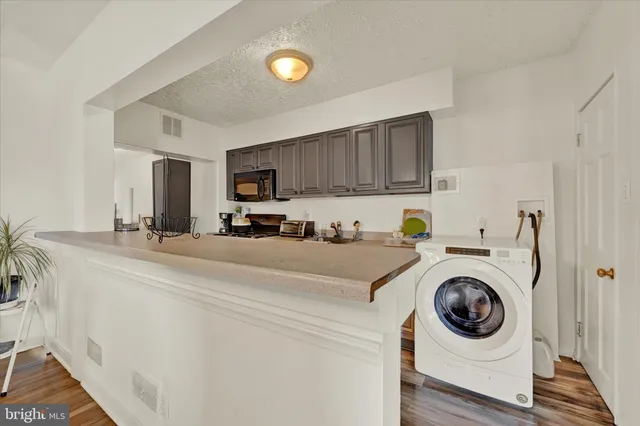 a view of kitchen sink and washer dryer