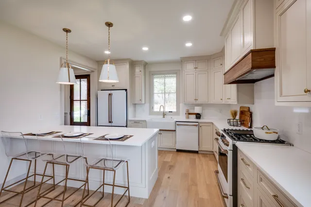 a kitchen that has a lot of cabinets in it and appliances