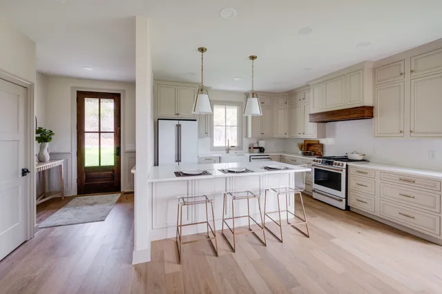 a stove top oven sitting inside of a kitchen