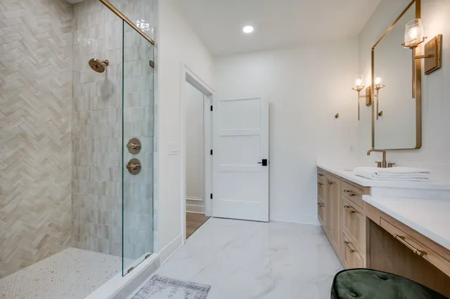 a bathroom with double vanity sinks and a mirror