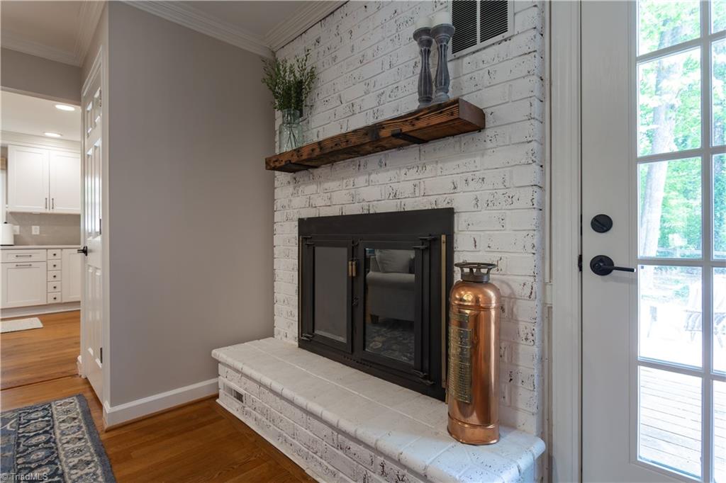 4200 Hobbs Road Greensboro, NC 27410 - Photo 21 of 36 BEAUTIFUL living room fireplace and surround out to two tier deck.