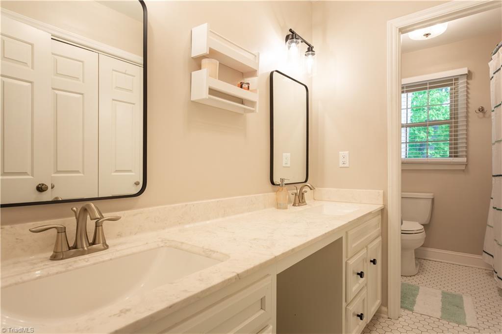 4200 Hobbs Road Greensboro, NC 27410 - Photo 27 of 36 3rd full bath with dual vanities and well spaced for families with multiple kids/occupants.