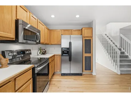 a kitchen with stainless steel appliances granite countertop a stove a sink and a refrigerator