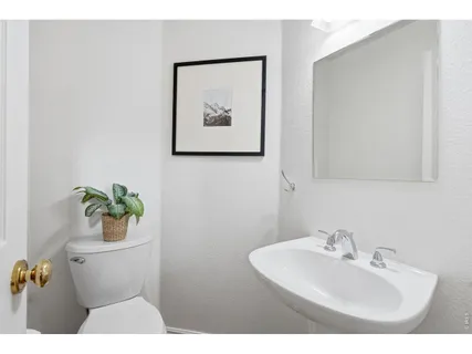 a bathroom with a sink mirror and toilet