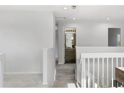 a view of hallway with wooden floor