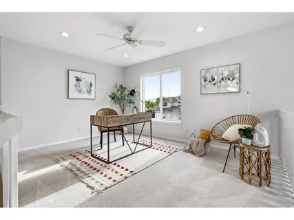 a living room with furniture and a dining table
