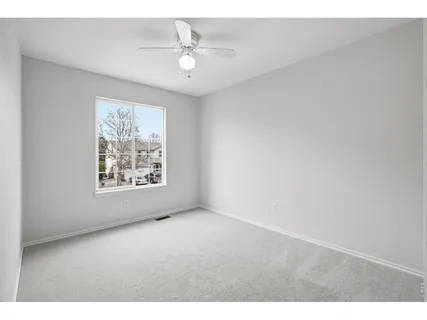 a view of an empty room with windows