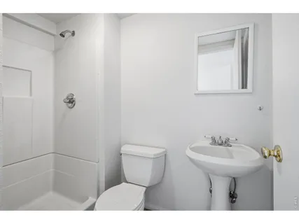 a bathroom with a sink toilet and a mirror