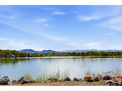 a view of a lake with houses in the back