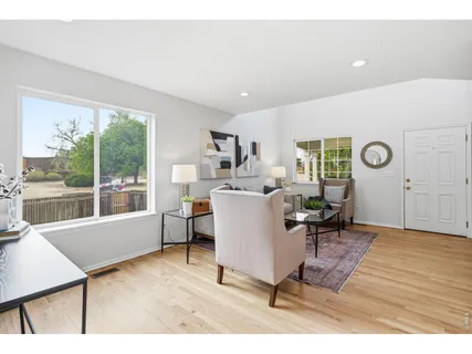a living room with furniture a window and a table