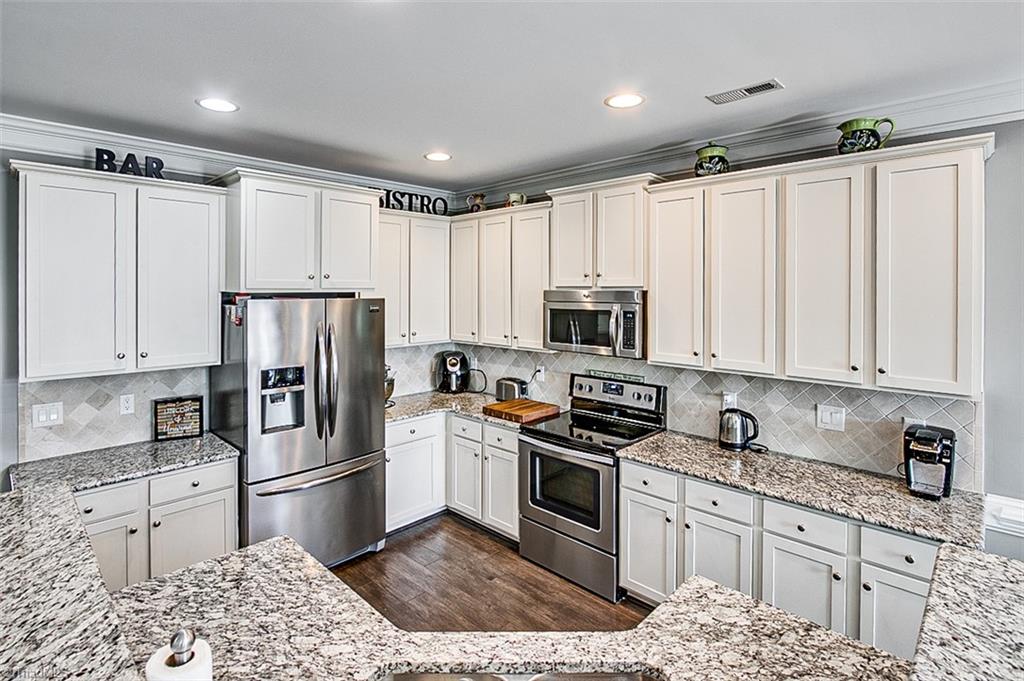 689 Nikyle Circle High Point, NC 27265 - Photo 13 of 33 Kitchen, hardwoods & shaker cabinets