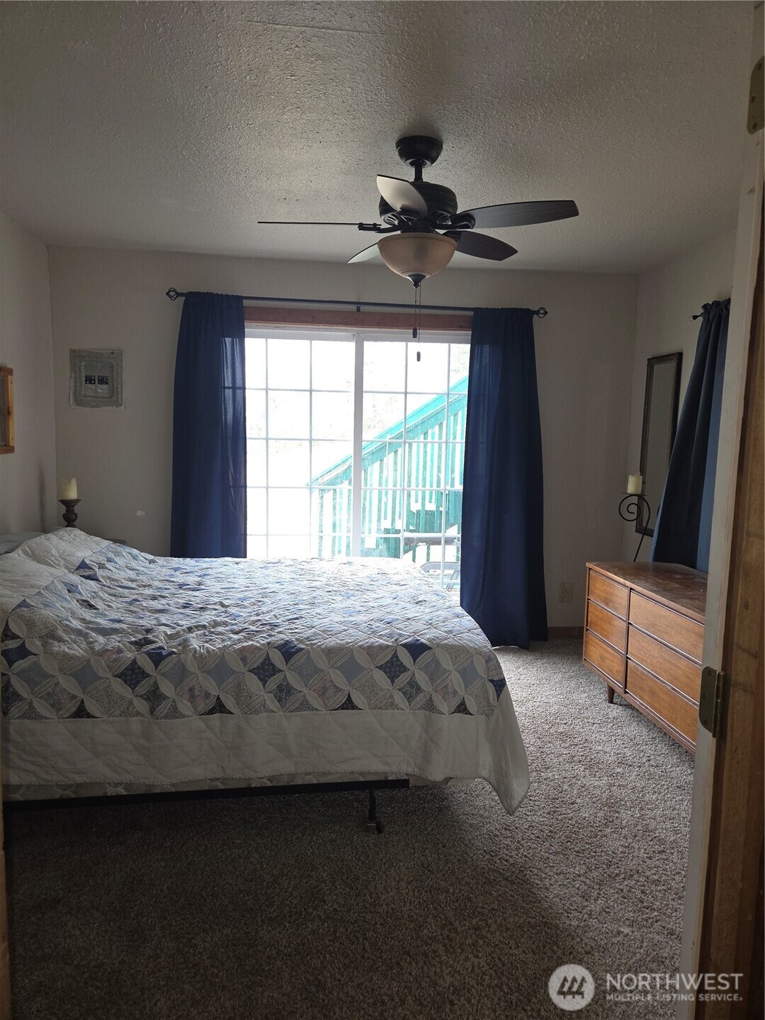 83 East Cayuse Mountain Road Tonasket, WA 98855 - Photo 9 of 37 a bedroom with a bed and a large window