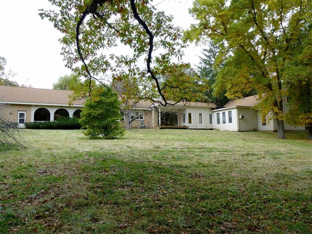 613 Three Oaks Road Cary, IL 60013 - Photo 22 of 25 a front view of a house with a yard