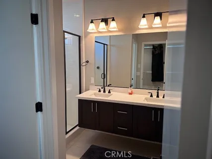 a bathroom with a double vanity sink and a mirror