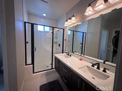 a bathroom with a double vanity sink a and a mirror
