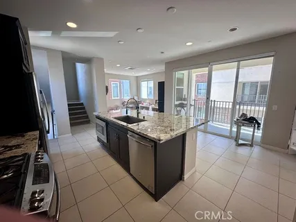 a kitchen with stainless steel appliances granite countertop a sink and a stove