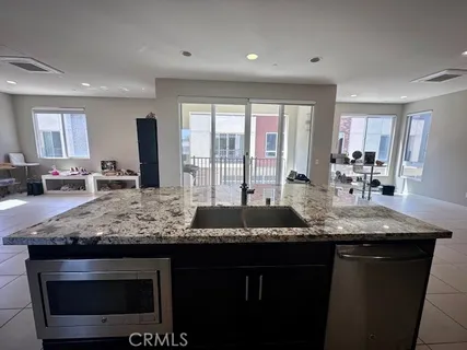 a kitchen with granite countertop kitchen island a counter space and stainless steel appliances