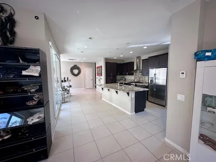 a kitchen with stainless steel appliances kitchen island granite countertop a stove and a refrigerator