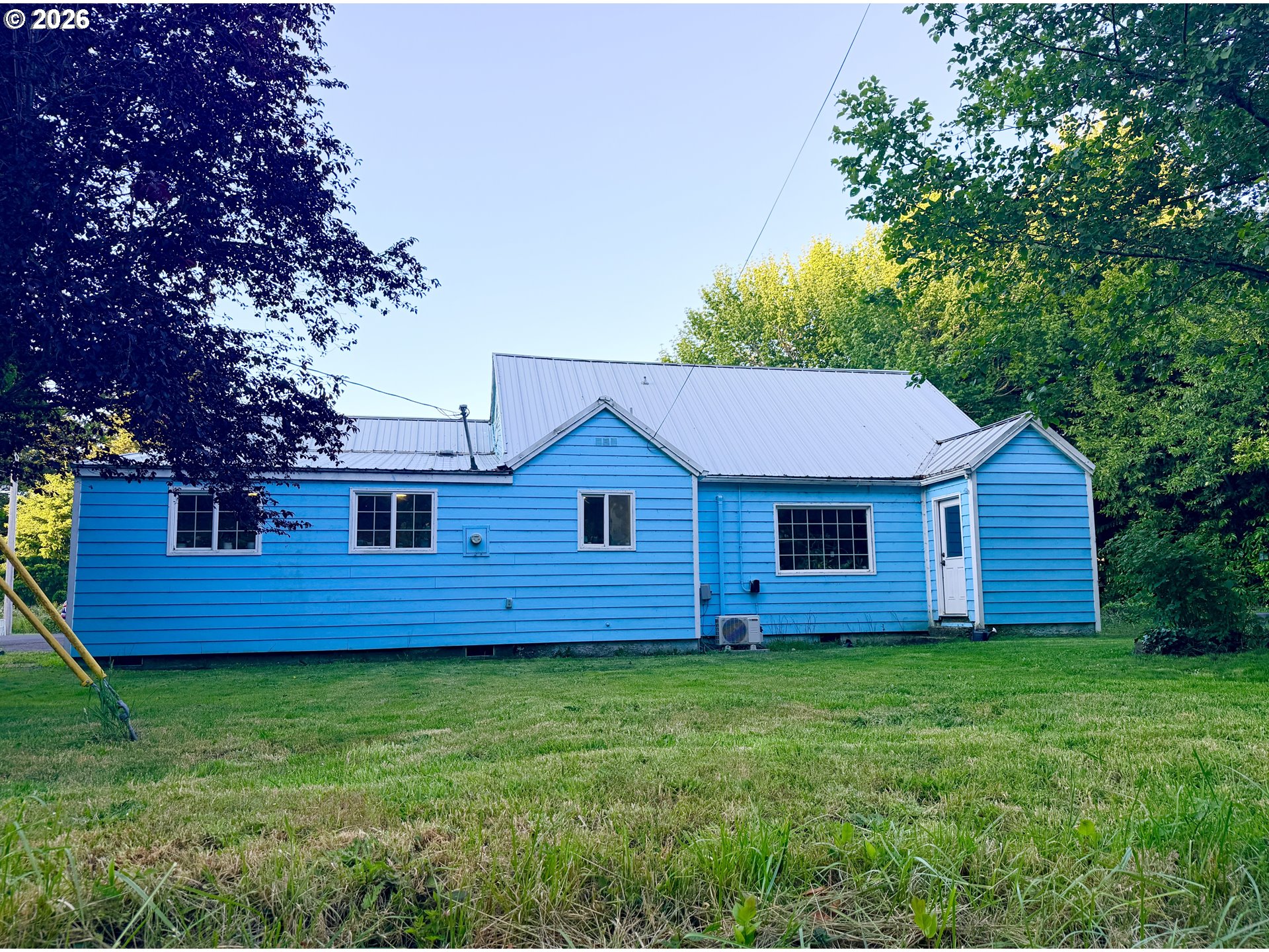 677 Southeast Moffitt Road Waldport, OR 97394 - Photo 2 of 36 a view of a house with a backyard
