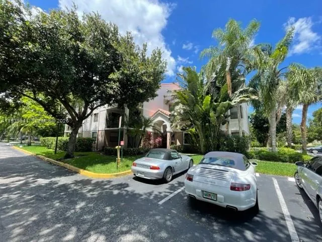 a sign that is sitting in front of a tree