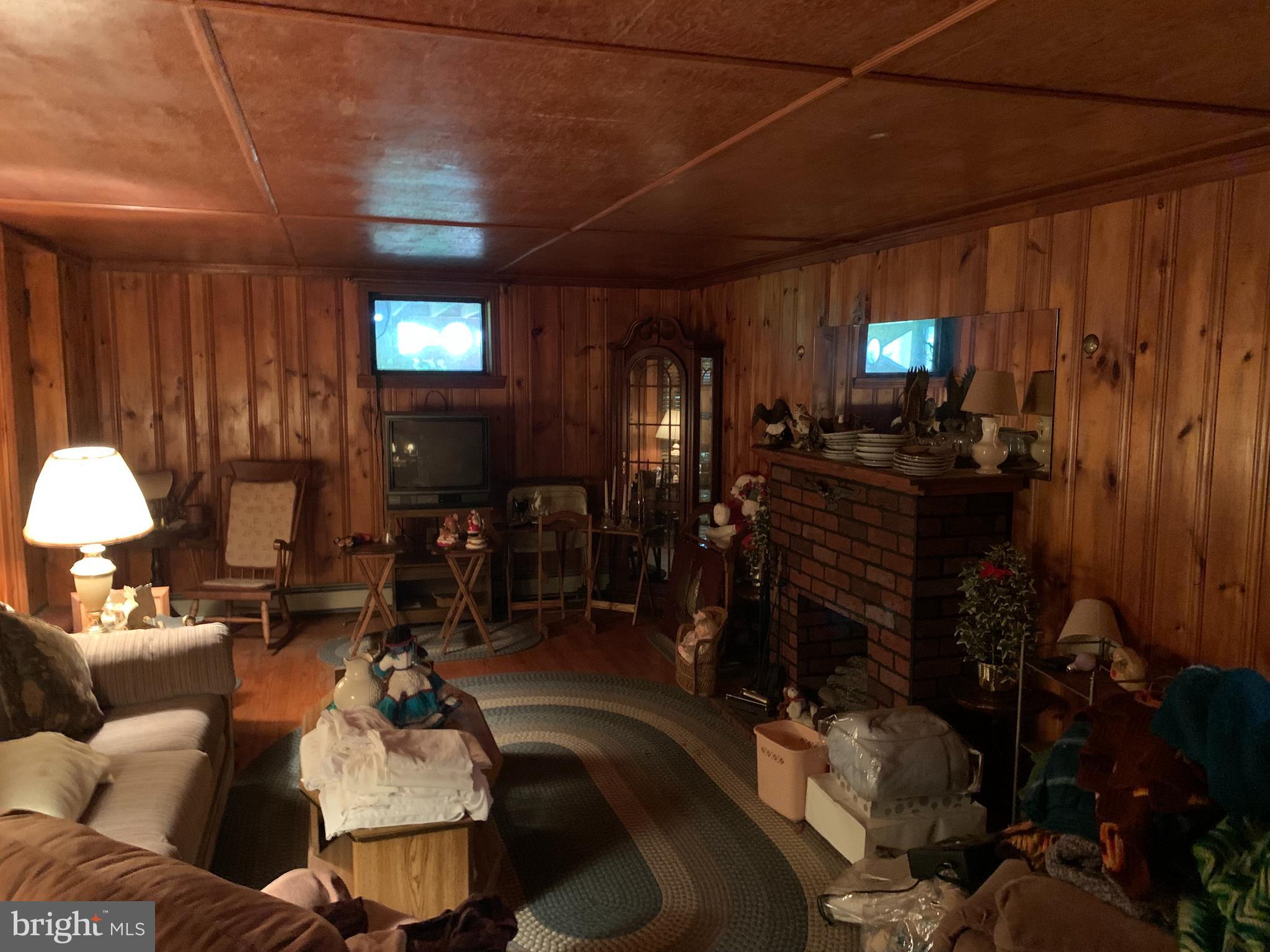 303 Meadowbrook Road Robbinsville, NJ 08691 - Photo 19 of 24 a living room with furniture a lamp and a fireplace