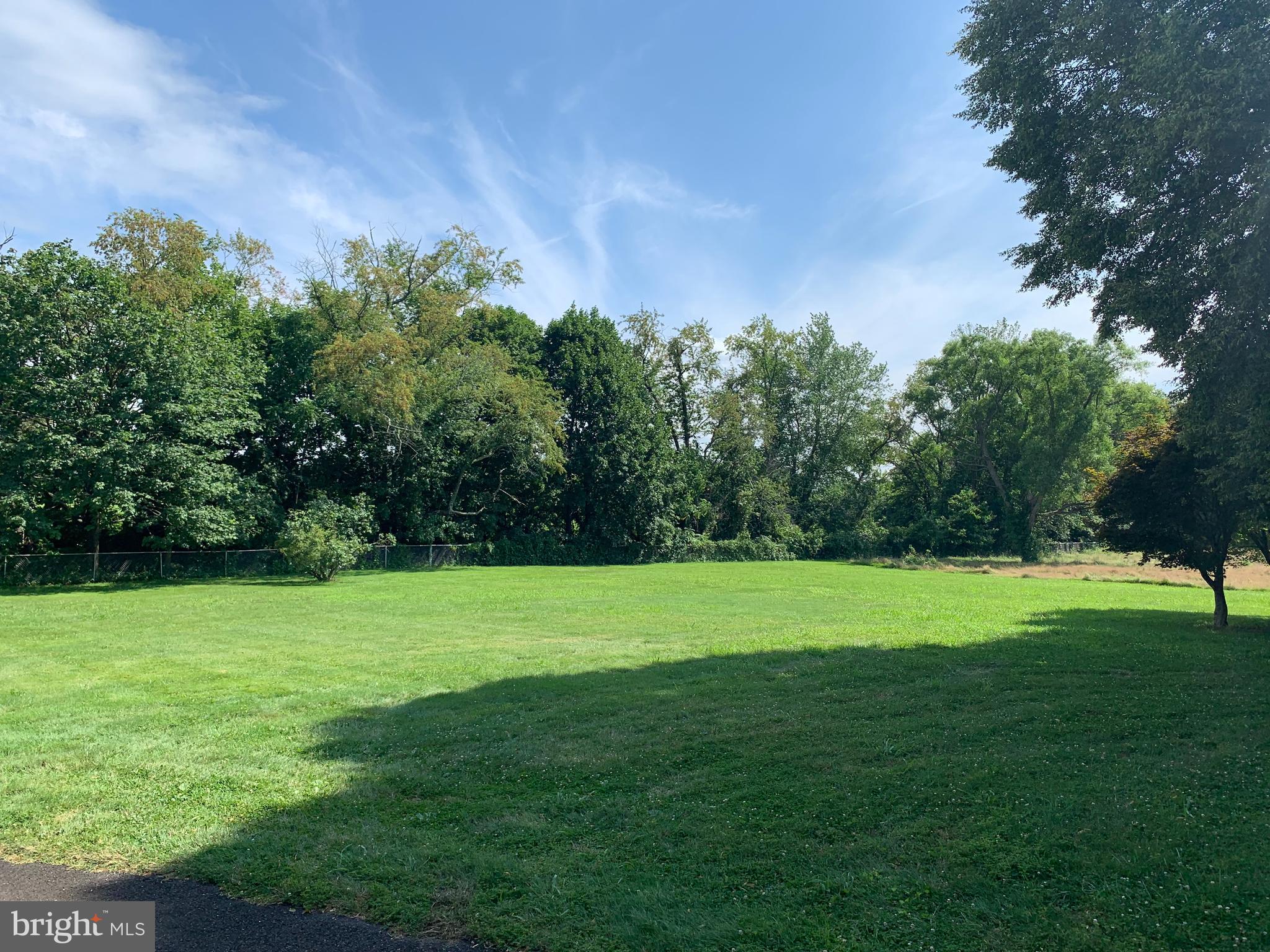 303 Meadowbrook Road Robbinsville, NJ 08691 - Photo 10 of 24 a view of a grassy field with trees