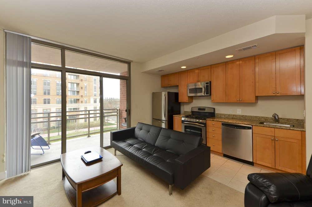 3650 South Glebe Road, Unit 349 Arlington, VA 22202 - Photo 4 of 21 a living room with furniture windows and kitchen view
