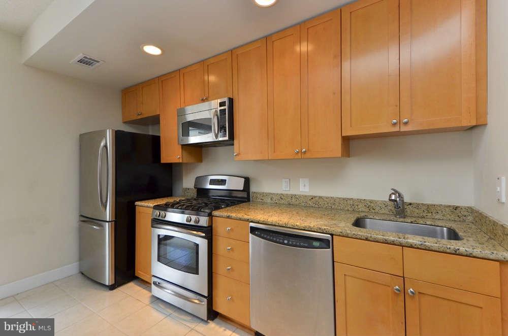 3650 South Glebe Road, Unit 349 Arlington, VA 22202 - Photo 5 of 21 a kitchen with stainless steel appliances granite countertop a refrigerator sink and stove