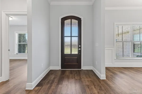 a living room with furniture or kitchen view and a wooden floor