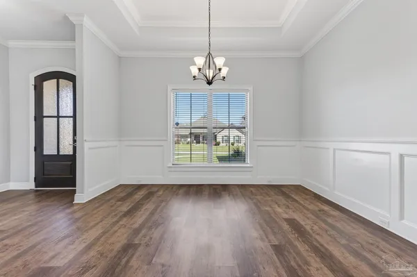 a kitchen with stainless steel appliances kitchen island granite countertop a table chairs sink and stove top oven