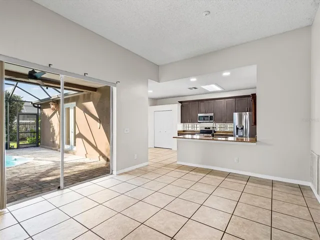 a view of kitchen with microwave and refrigerator