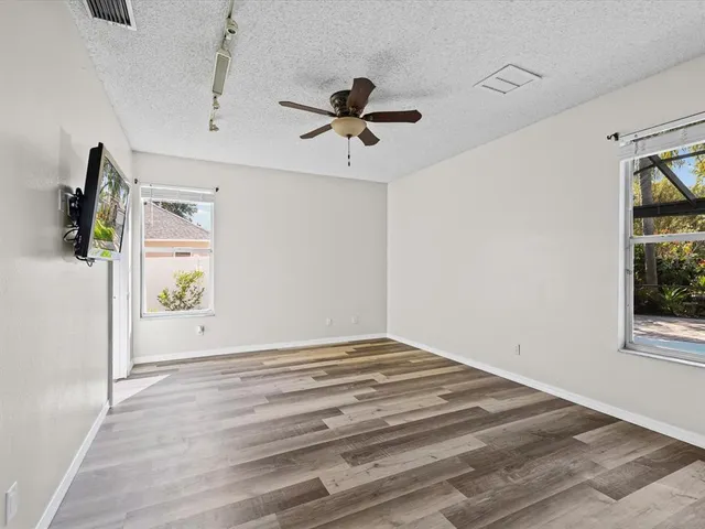 a view of a ceiling fan with wooden floor
