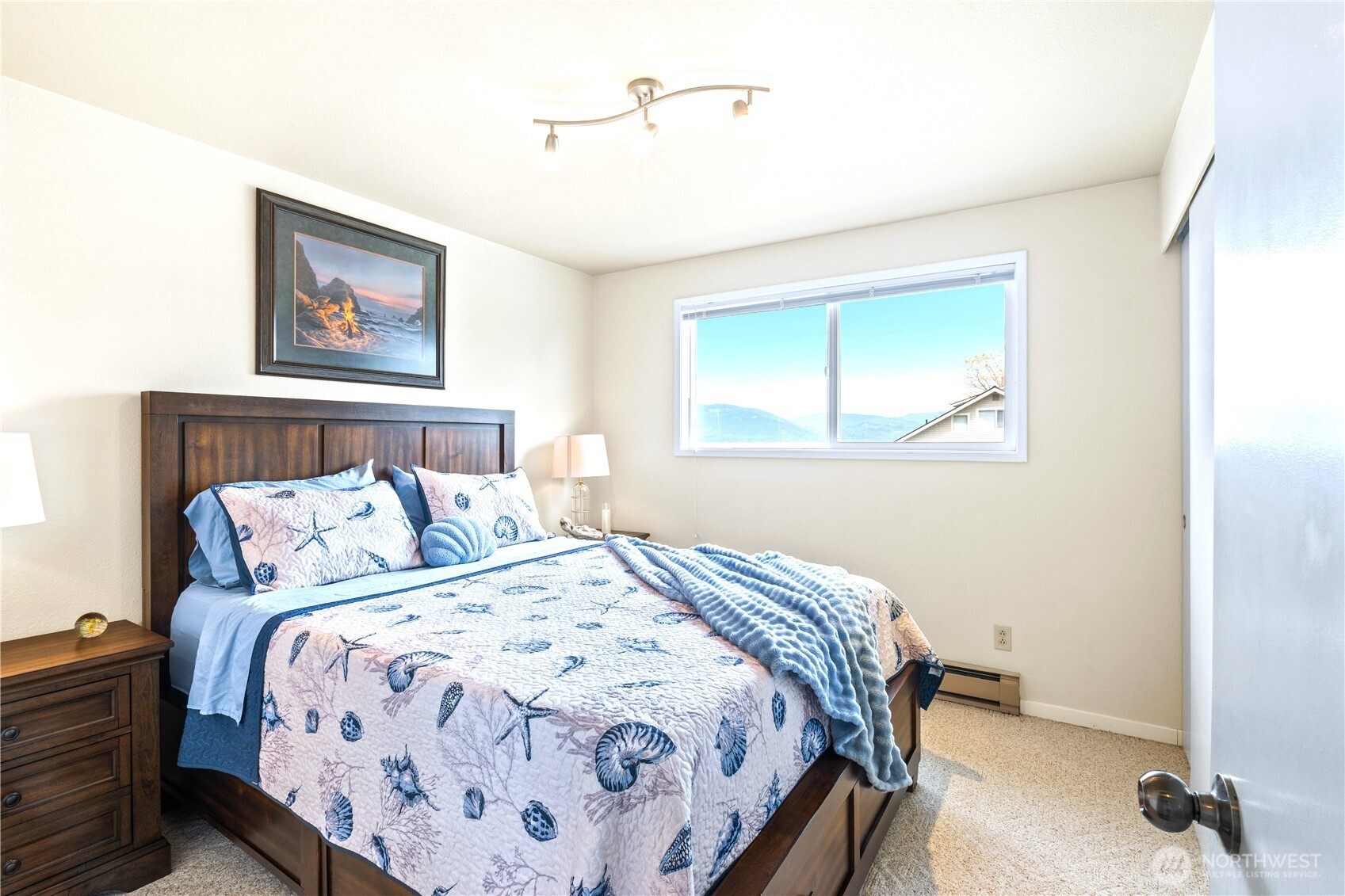9609 Samish Island Road Bow, WA 98232 - Photo 15 of 33 a bedroom with a bed and a window