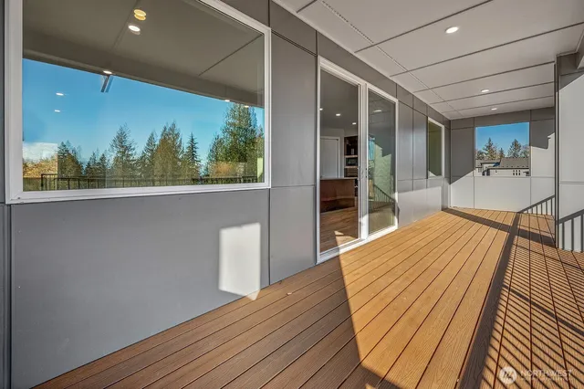 a view of a living room with wooden floor and a large window