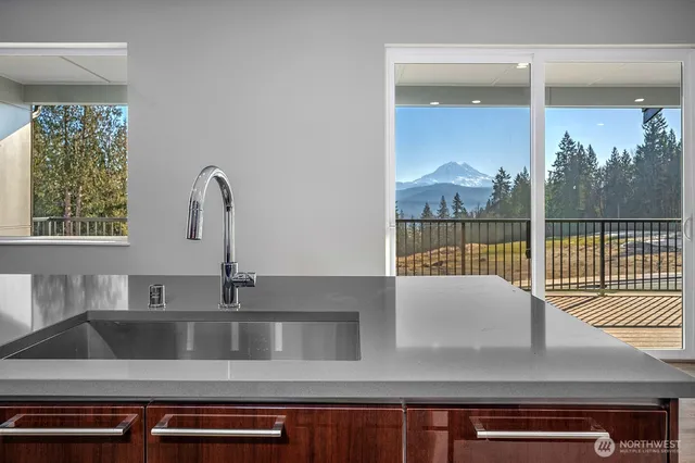 a view of kitchen with a sink and large window