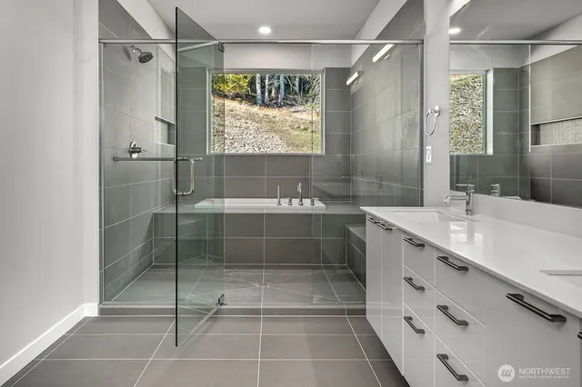 a bathroom with a shower sink and mirror
