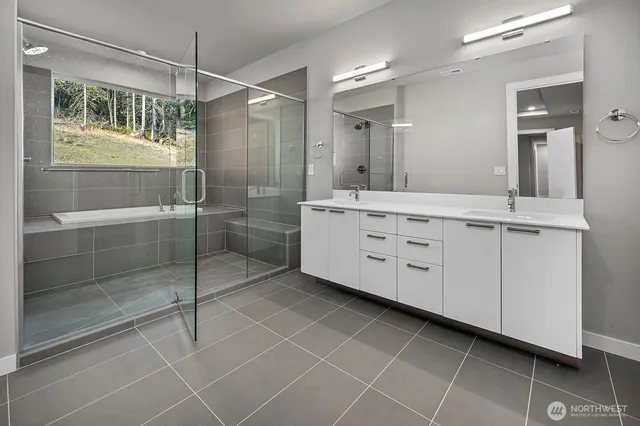 a bathroom with a granite countertop sink a mirror and a shower