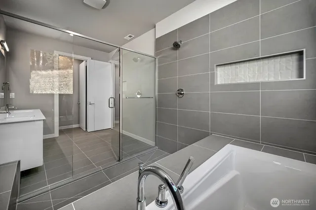 a bathroom with a bathtub and a shower
