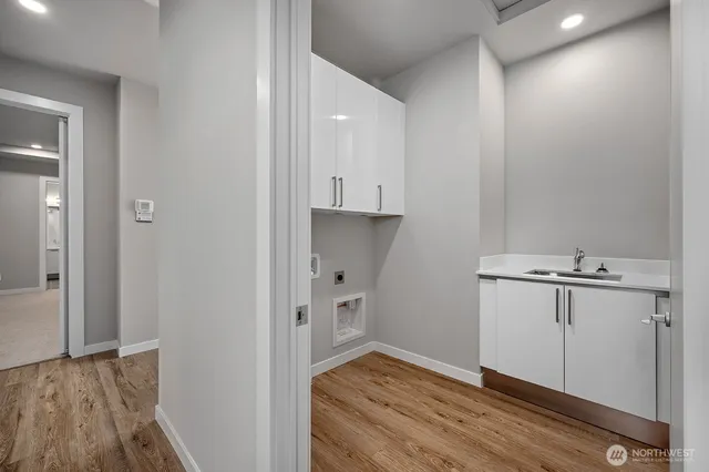 a view of wooden floor and closet in a kitchen