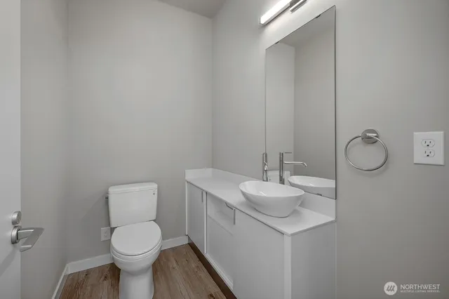 a bathroom with a toilet sink and mirror