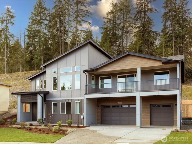 a front view of a house with garage and yard
