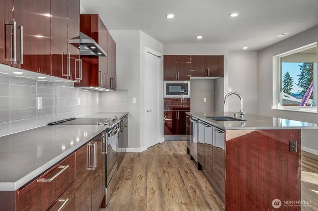 a kitchen with stainless steel appliances granite countertop a stove and a sink