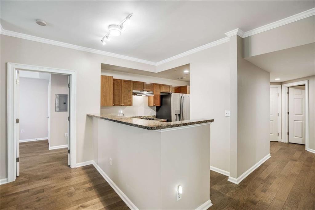 3275 Lenox Road Northeast, Unit 302 Atlanta, GA 30324 - Photo 12 of 50 a kitchen with stainless steel appliances granite countertop a refrigerator and a sink
