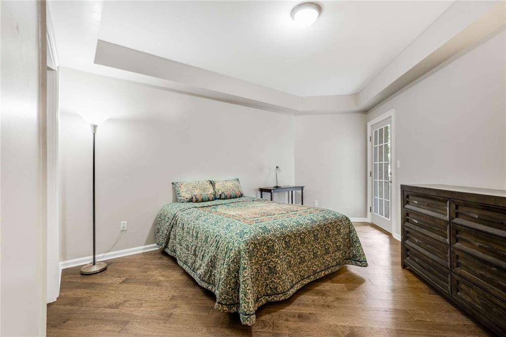 3275 Lenox Road Northeast, Unit 302 Atlanta, GA 30324 - Photo 25 of 50 a bedroom with a bed and cabinets