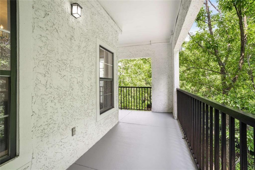 3275 Lenox Road Northeast, Unit 302 Atlanta, GA 30324 - Photo 29 of 50 a view of a porch with wooden floor and fence