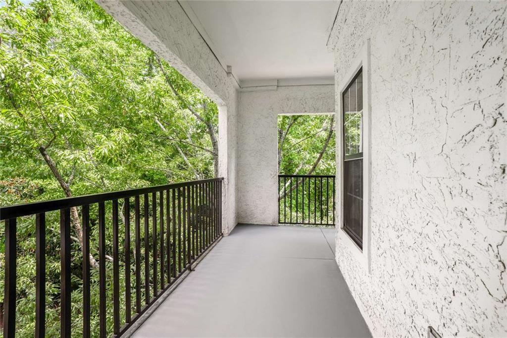 3275 Lenox Road Northeast, Unit 302 Atlanta, GA 30324 - Photo 33 of 50 a view of a porch with wooden floor and fence